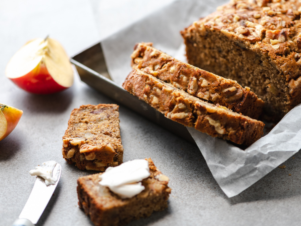 Apple Banana Bread Sliced with Sliced Apples on a Countertop