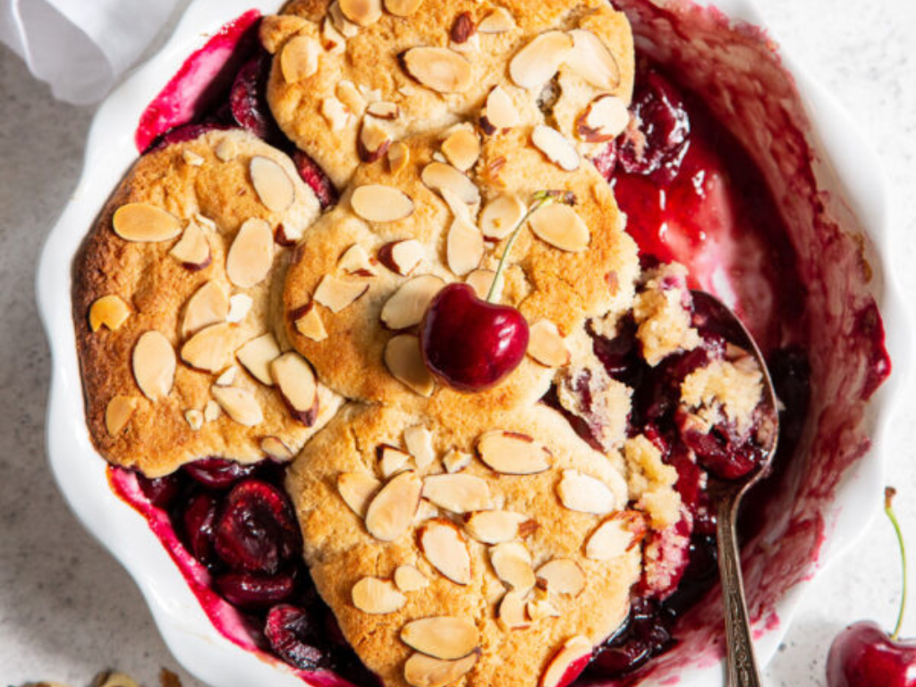 Paleo Vegan Cherry Almond Cobbler Being Scooped with a Spoon