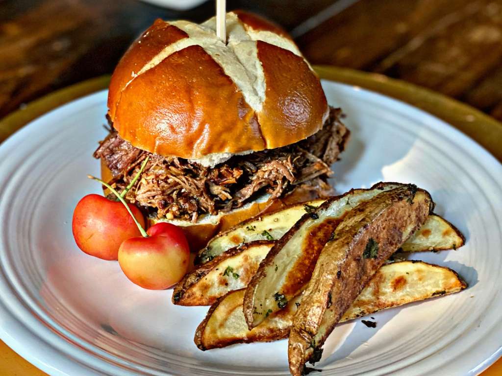 Rainier Cherry Beef Carnitas Sandwiches on a Plate with Cherries and Potato Wedges